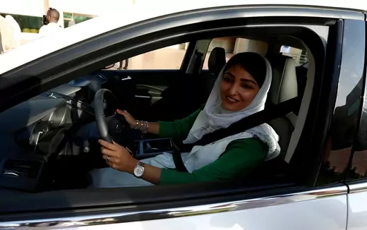 Saudi woman sits in a car during a driving training at a university in Jeddah.