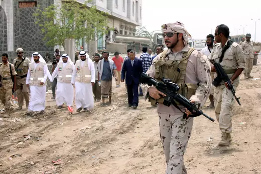 An Emirati soldier escorts Yemen's prime minister in the port city of Mukha.