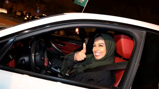 A Saudi woman celebrates as she drives her car in her neighborhood, in Al Khobar, Saudi Arabia, June 24, 2018. 