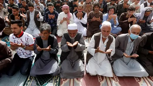 People take part in morning prayers in Kabul