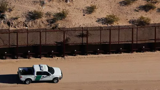 U.S. border patrol truck drives along border fence between Mexico and Sunland Park, New Mexico