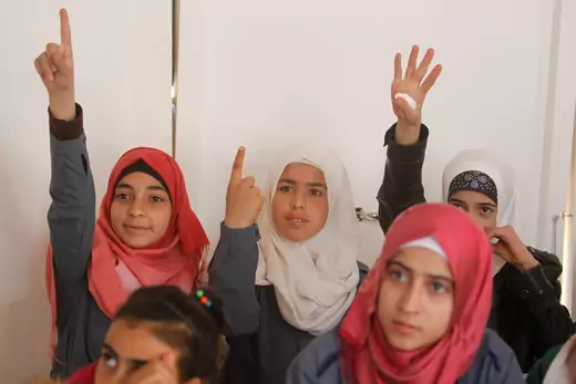 Syrian refugee girls gesture as they sit inside a classroom at a school for Syrian refugee girls in Lebanon, October 19, 2017. 