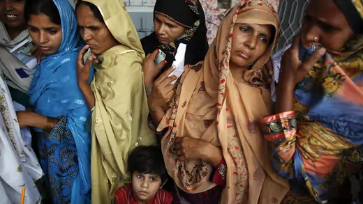 Women wait to vote at a polling station in a village near Lahore.