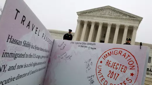 A mock-up of a Muslim traveler’s passport is placed outside the U.S. Supreme Court.