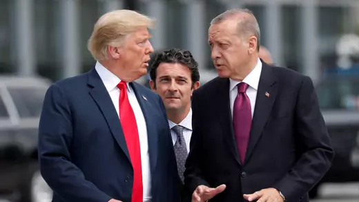 U.S. President Donald Trump and Turkish President Tayyip Erdogan gesture as they talk at the start of the NATO summit in Brussels, Belgium on July 11, 2018.