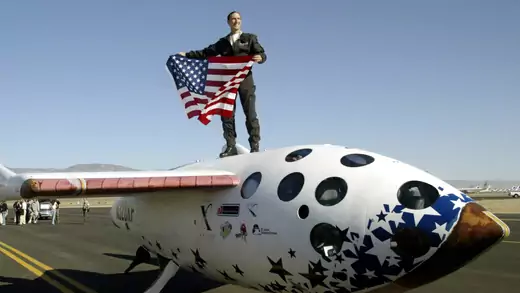 Pilot Brian Binnie stands atop SpaceShipOne after winning the $10 million Ansari X Prize in Mojave, California October 4, 2004. The prize was awarded after SpaceShipOne became the first commercial spaceship to reach suborbit in two successful attempts.