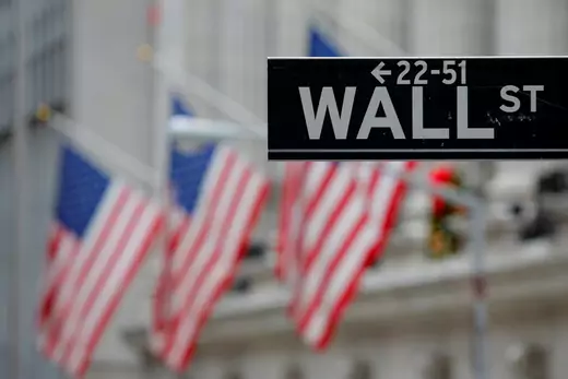 A street sign for Wall Street is seen outside the New York Stock Exchange (NYSE) in Manhattan, New York City.