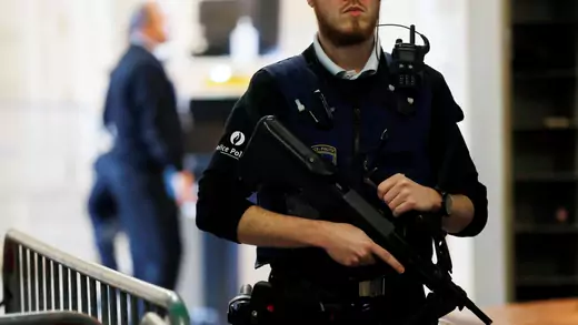A Belgian police officer stands guard outside a courtroom during the trial of one of the suspects in the 2015 Islamic State attacks.