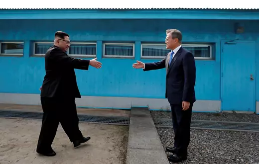South Korean President Moon Jae-in and North Korean leader Kim Jong Un shake hands at inside the demilitarized zone separating the two Koreas, April 27, 2018.