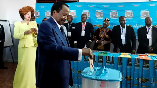 Cameroonian President Paul Biya casts his ballot while his wife Chantal watches during the presidential election in Yaounde, Cameroon October 7, 2018.