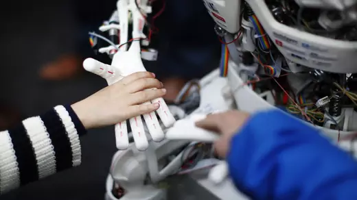 Children touch the hands of the humanoid robot Roboy at the exhibition Robots on Tour in Zurich on March 9, 2013. 