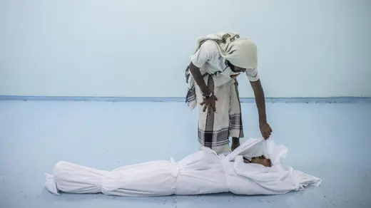 A combatant killed in Hodeidah is attended to at the morgue of a field hospital.