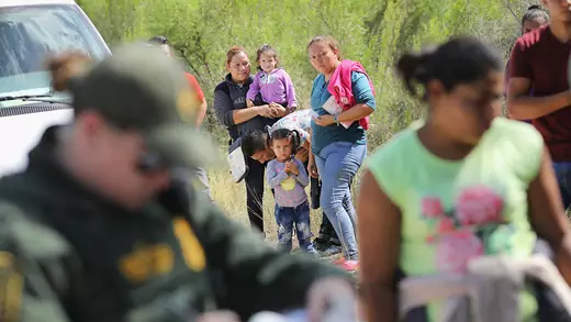 Central American asylum seekers wait as U.S. Border Patrol agents take them into custody near McAllen, Texas. The families were then sent to a U.S. Customs and Border Protection (CBP) processing center for possible separation.