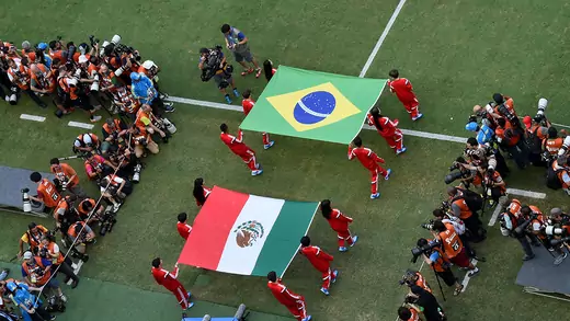  Flag bearers carry the Mexican and Brazilian flags out onto the pitch prior to the 2014 FIFA World Cup Brazil Group A match between Brazil and Mexico at Castelao on June 17, 2014 in Fortaleza, Brazil.