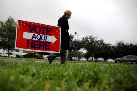A woman arrives at a polling station as the early voting for midterm elections started in Texas, October 22, 2018. 