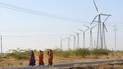 Women walk among windmills in Jaisalmer, India, on March 8, 2017.