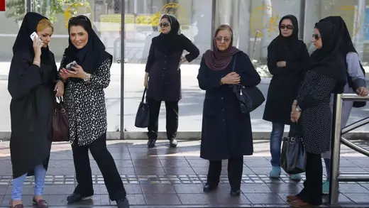 Women wait for a bus in central Tehran, Iran.