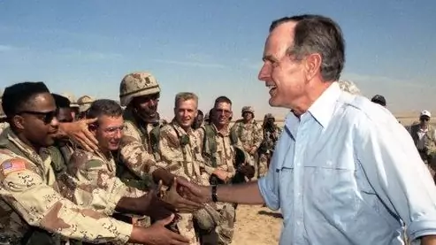 President George H.W. Bush greets troops in Saudi Arabia during a 1990 Thanksgiving visit. 