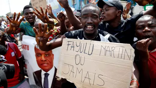Supporters of the runner-up in Democratic Republic of Congo's presidential election, Martin Fayulu hold a sign before a political rally in Kinshasa, Democratic Republic of Congo, January 11, 2019. 