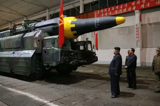North Korean leader Kim Jong Un, left, inspects a Hwasong-12 ballistic missile at an undisclosed location on May 14, 2017. (Korean Central News Agency/Korea News Service via Getty Images)
