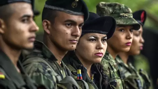 Members of the Revolutionary Armed Forces of Colombia stand during a ceremony at a camp in the Colombian mountains.