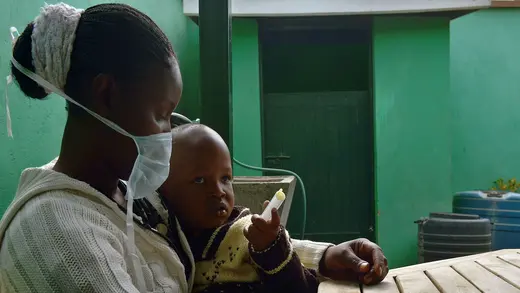 A mother holds her three-year-old boy, who suffers from multidrug-resistant tuberculosis, after giving him medication at a Doctors Without Borders–run clinic in Nairobi, Kenya, on World Tuberculosis Day.
