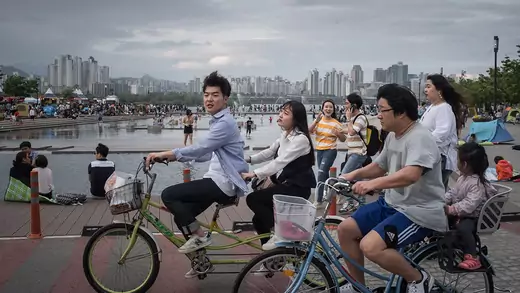 Youths ride bicycles in Yeouido Park in Seoul.