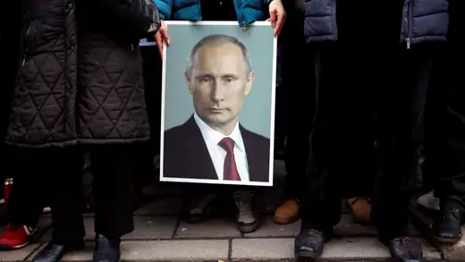 A supporter of Russian President Vladimir Putin holds his portrait in Belgrade, Serbia, January 18, 2019.