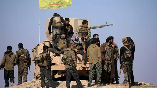 Syrian Democratic Forces stand together near Baghouz, Syria