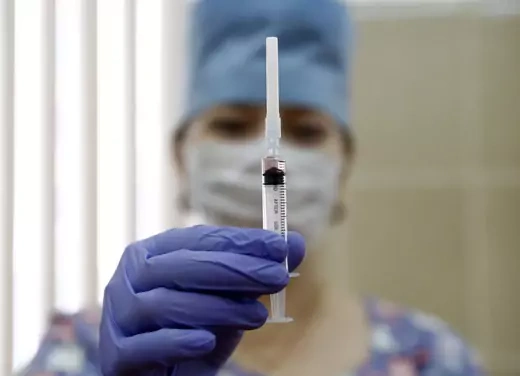 A medical staff worker with a syringe containing vaccine for measles and mumps at a clinic in Moscow, Russia.