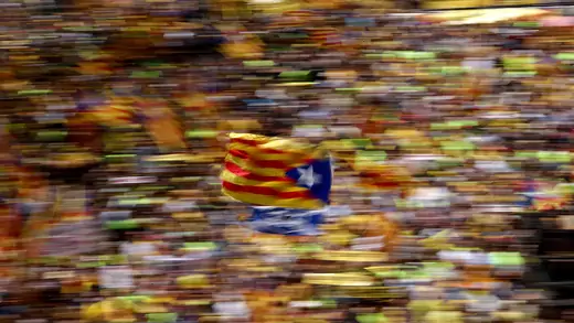A pro-independence supporter waves a Catalan separatist flag during a demonstration in Barcelona, Spain.