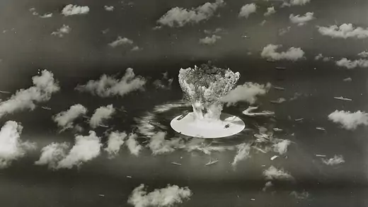 A mushroom cloud rises with ships below during the Operation Crossroads nuclear weapons test on Bikini Atoll, Marshall Islands. 