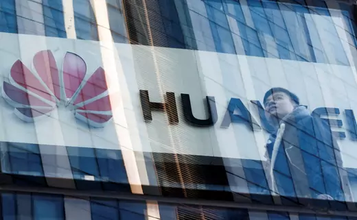 A man walks past Huawei offices in Beijing.