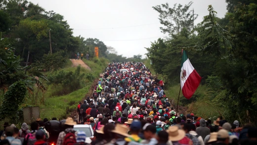 Central Americans en route to the United States walk along a highway in Mexico.