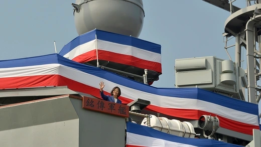 Taiwanese President Tsai Ing-wen waves on the deck of a warship purchased from the United States.