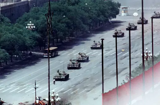 A Beijing man stands in front of tanks on the Avenue of Eternal Peace.