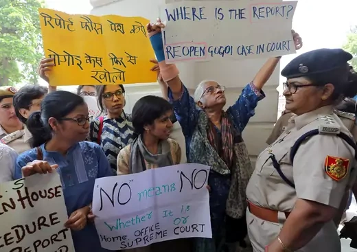 Demonstrator hold placards during a protest after a panel of judges dismissed a sexual harassment complaint against Chief Justice of India (CJI) Ranjan Gogoi in New Delhi, India, May 8, 2019.