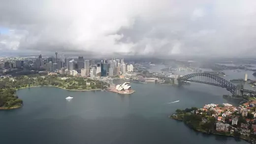 A rainbow forms across Sydney Harbour.
