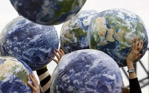 People hold up inflatable world globes during World Environment Day celebrations in Sydney, Australia on June 5, 2009. 
