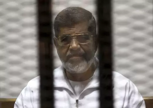 Ousted Egyptian President Mohamed Mursi is seen behind bars during his trial at a court in Cairo May 8, 2014. 