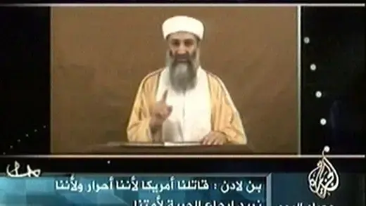 Osama bin Laden appearing on TV screen.