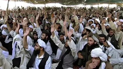 Pro-Taliban supporters shout slogans during a rally in Killi Nalai village.