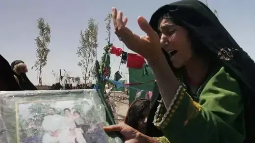 An Afghan woman mourns family members who were killed in Herat Province.