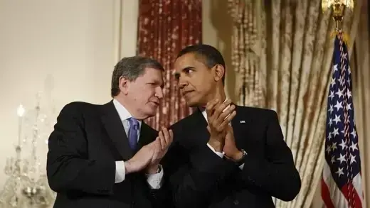 President Obama speaks with Richard Holbrooke.