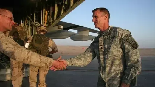 The head of U.S. and NATO forces in Afghanistan, U.S. Gen. Stanley McChrystal shakes hands with a marine before boarding a military plane.