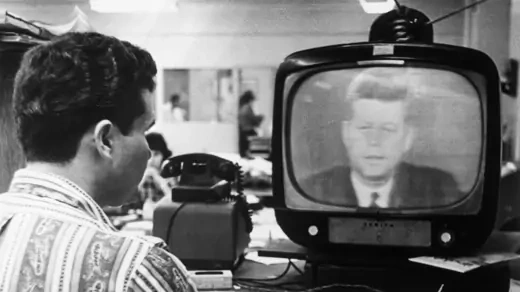 Man watches  President Kennedy's television address.