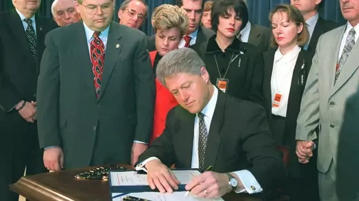 President Clinton signs the Helms-Burton bill.