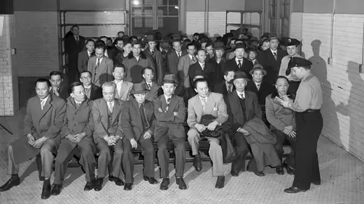 Chinese immigrants undergo an interrogation at Ellis Island.