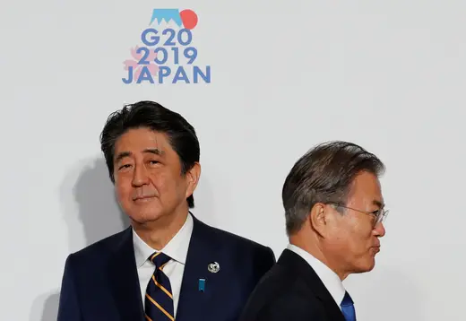 South Korean President Moon Jae-in is welcomed by Japanese Prime Minister Shinzo Abe upon his arrival for a welcome and photo session at G20 leaders summit in Osaka, Japan, on June 28, 2019.