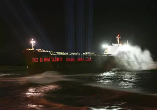 A laser, operated by the environmental group Greenpeace, projects a slogan onto the 40,000 tonne coal ship Pasha Bulker June 27, 2007 as it sits about 330 feet from Nobbys Beach after running aground near the coal port of Newcastle on Australia's east coast on June 8, 2007.